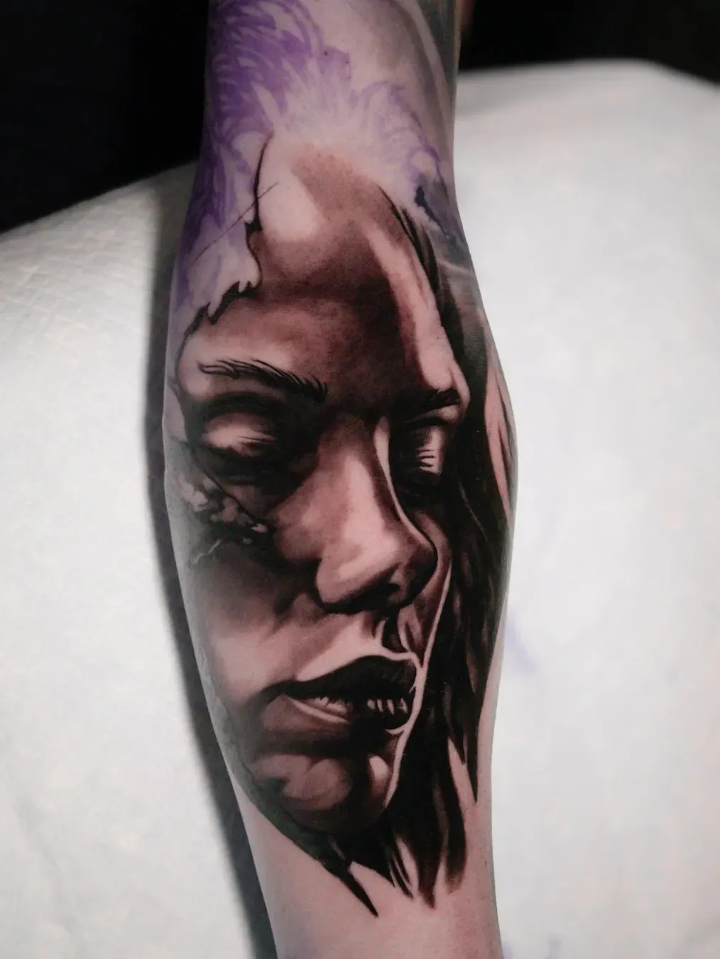 Power in stillness: the freshly tattooed portrait, with traces of the purple stencil still visible